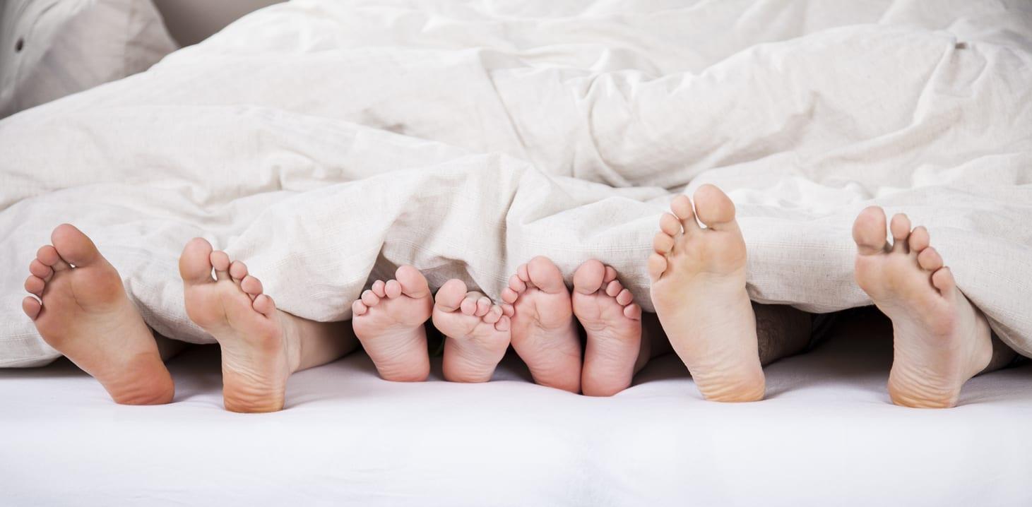 Family feet in bed