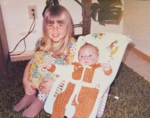 Jodee, as a young girl, and her baby brother Brett